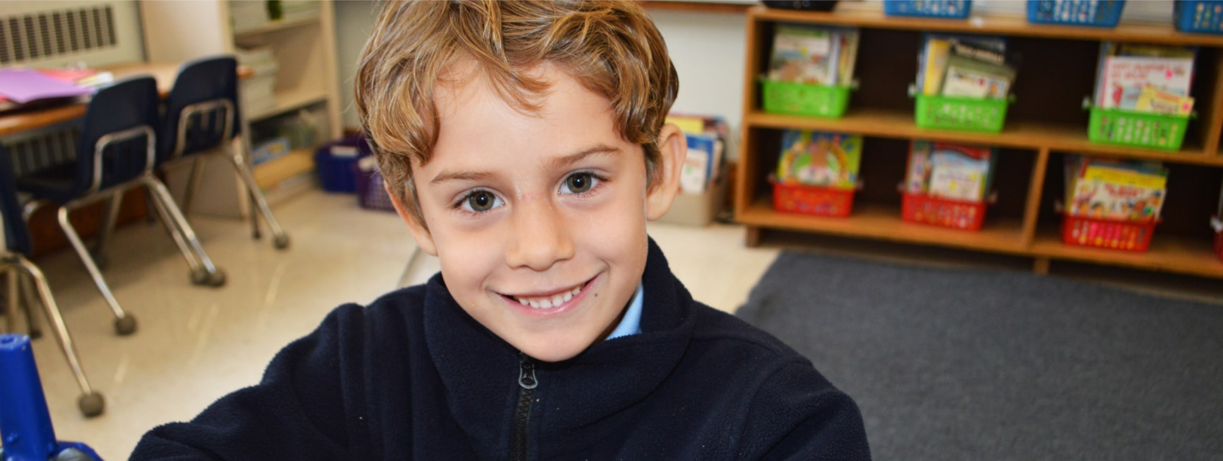 Catholic school student smiling at camera